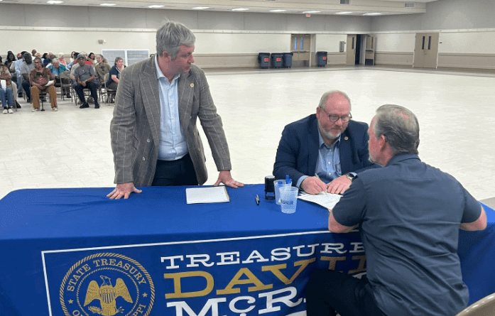 State Treasurer David McRae (left) looks on at an unclaimed money event in Jackson County, March 2026 (Photo from McRae's Facebook)